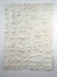 An off white root system silk screened on felt trails across the surface of this contemplative fabric wall sculpture by Chung-Im Kim.