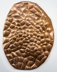 The organic intersects the enigmatic in this reflective copper wall relief by Jana Osterman.