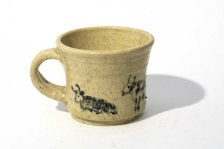 This unique ceramic mug by Joe Fafard is signed on the bottom.