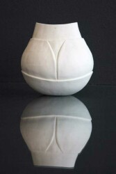 This small porcelain vessel is glazed on the interior, matte on the exterior.