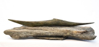 Hand carved and cast bronze kayak, on granite stone.