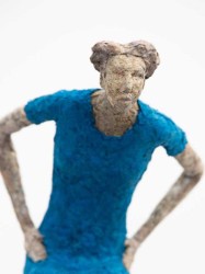 Perched on a silver leaf plinth, a seated figure in blue gestures to the viewer in this small scale sculpture by Paul Duval.