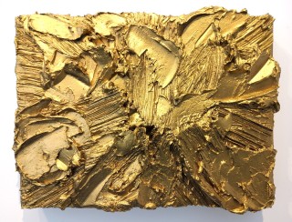 Swaths of thick gold paint, two inches deep in areas, are captured within the confines of a small wood panel by Shayne Dark.